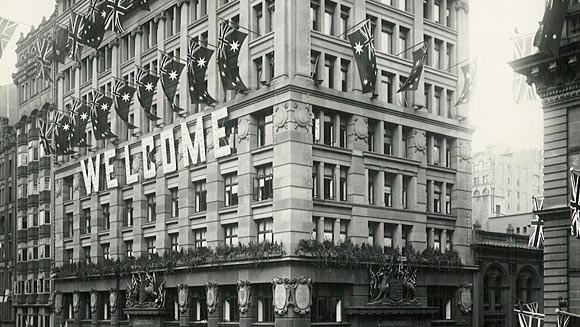 Photograph showing window boxes displaying masses of scarlet and green used as a decorative effect for large buildings during the visit.